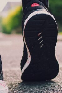 Person in Black Sneakers Walking on Street