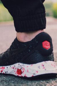 Person in Black Sneakers Walking on Street