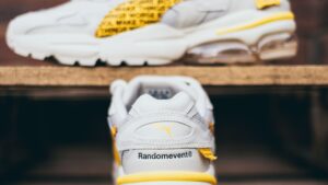 White and Yellow Rubber Shoes on a Wooden Surface